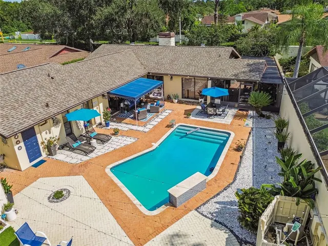 an aerial view of a house with a yard basket ball court and outdoor seating