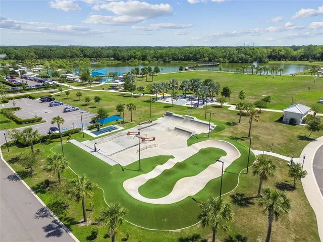 a view of a lake with a big yard and potted plants