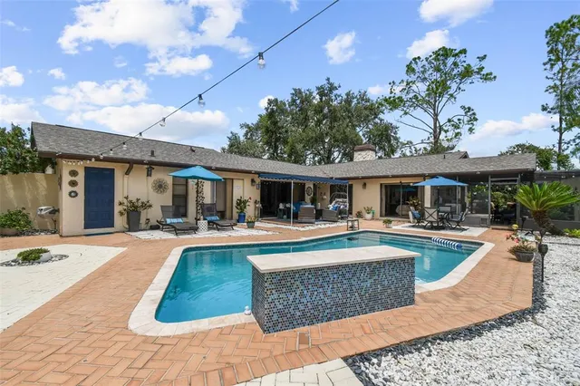 a view of a patio with a table and chairs under an umbrella