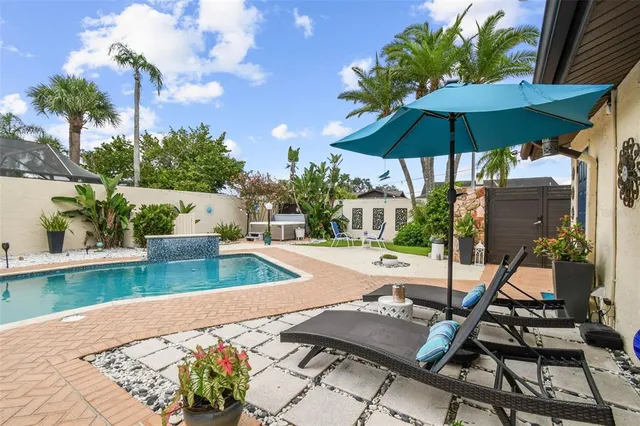 a living room with patio furniture and a floor to ceiling window