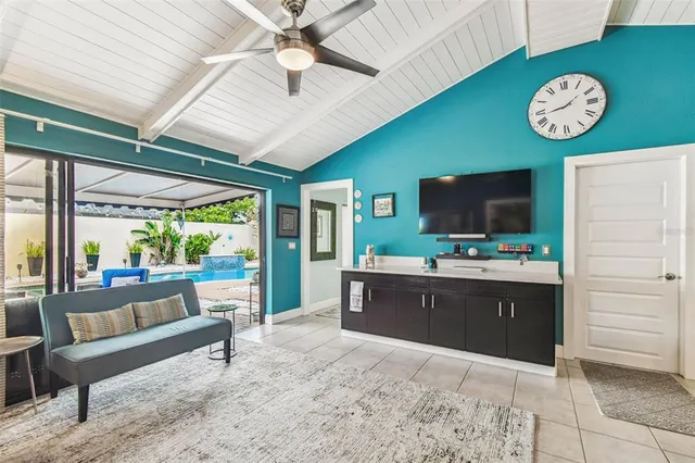 a view of a dining room and livingroom with furniture wooden floor and a chandelier
