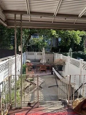 a wooden bench sitting in the middle of a yard