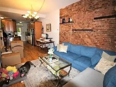 a living room with furniture and a chandelier