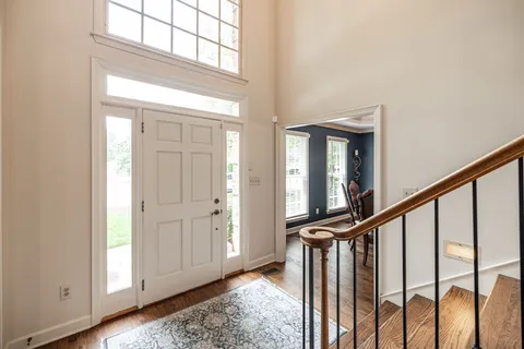 a living room with furniture a rug and a wooden floor