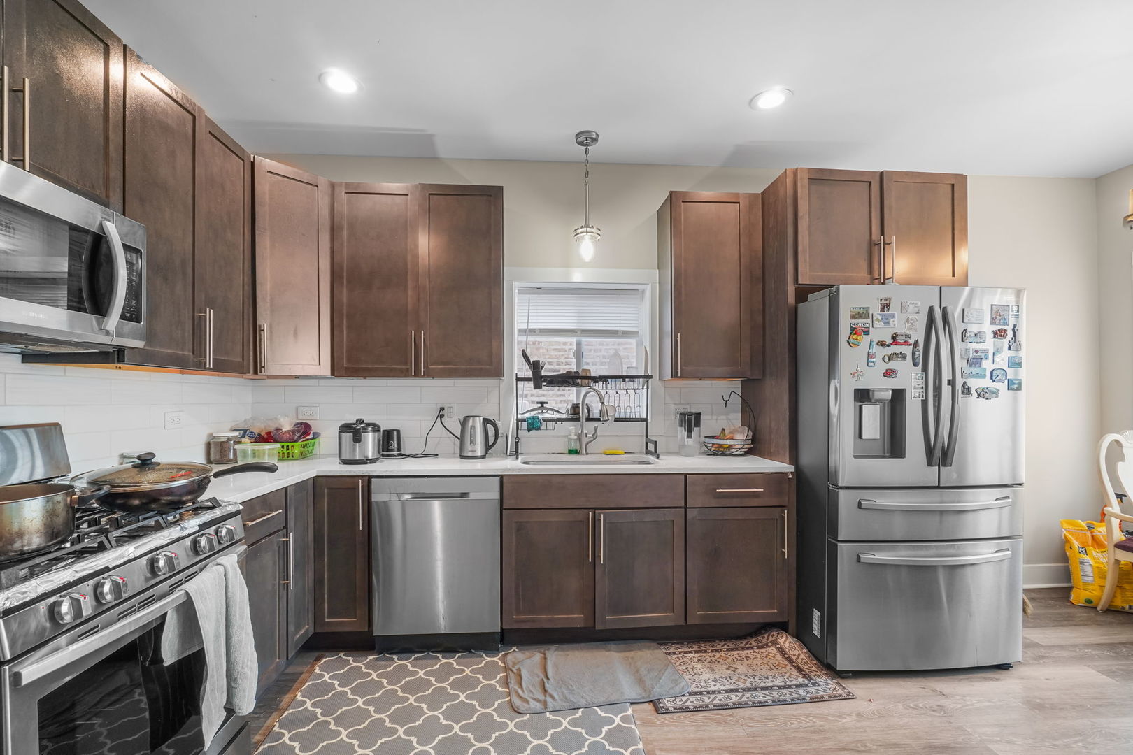 1906 South 60th Court Cicero, IL 60804 - Photo 14 of 40 a kitchen with stainless steel appliances a sink a stove a refrigerator cabinets and a counter top space