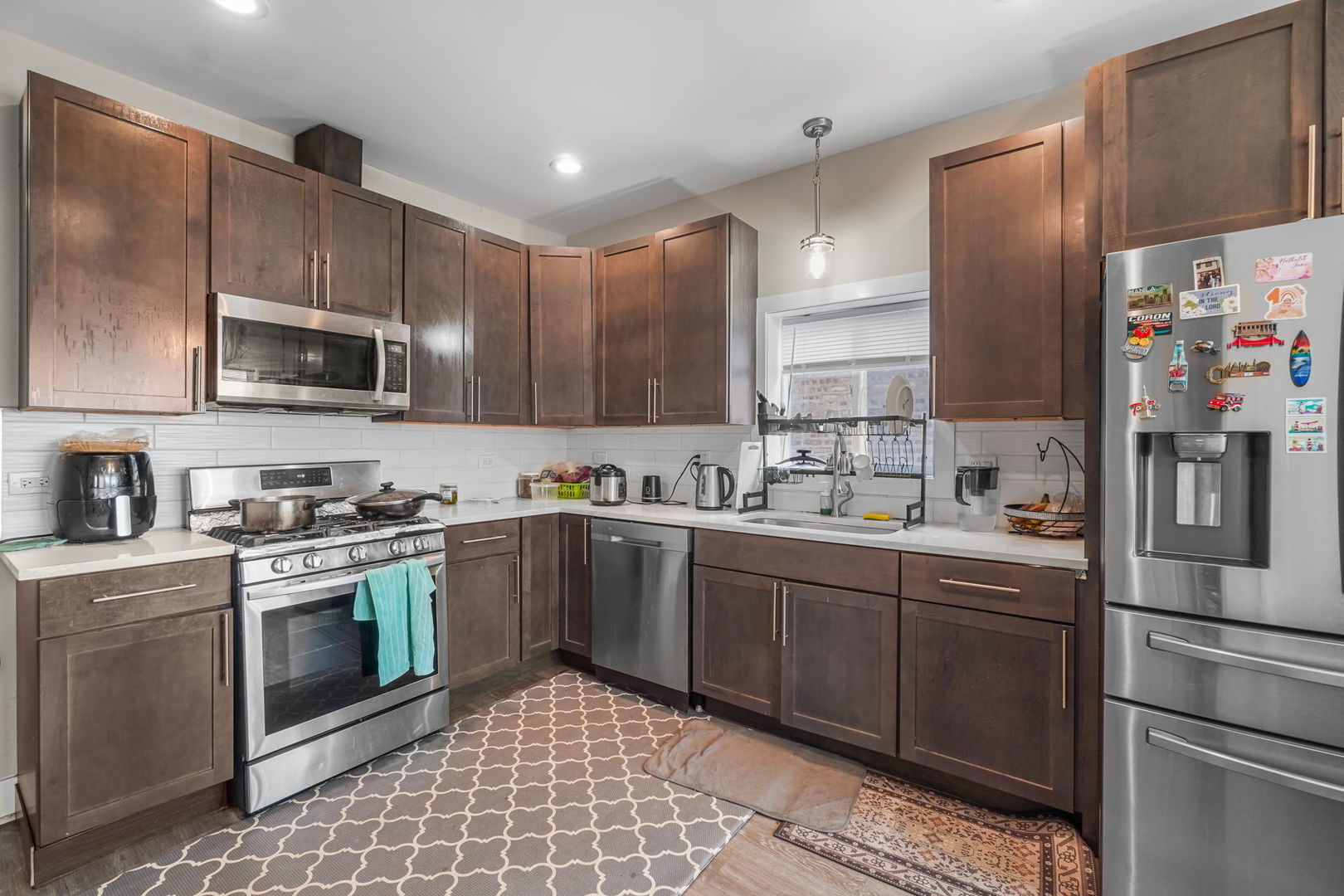 1906 South 60th Court Cicero, IL 60804 - Photo 15 of 40 a kitchen with stainless steel appliances granite countertop a stove a sink and a refrigerator