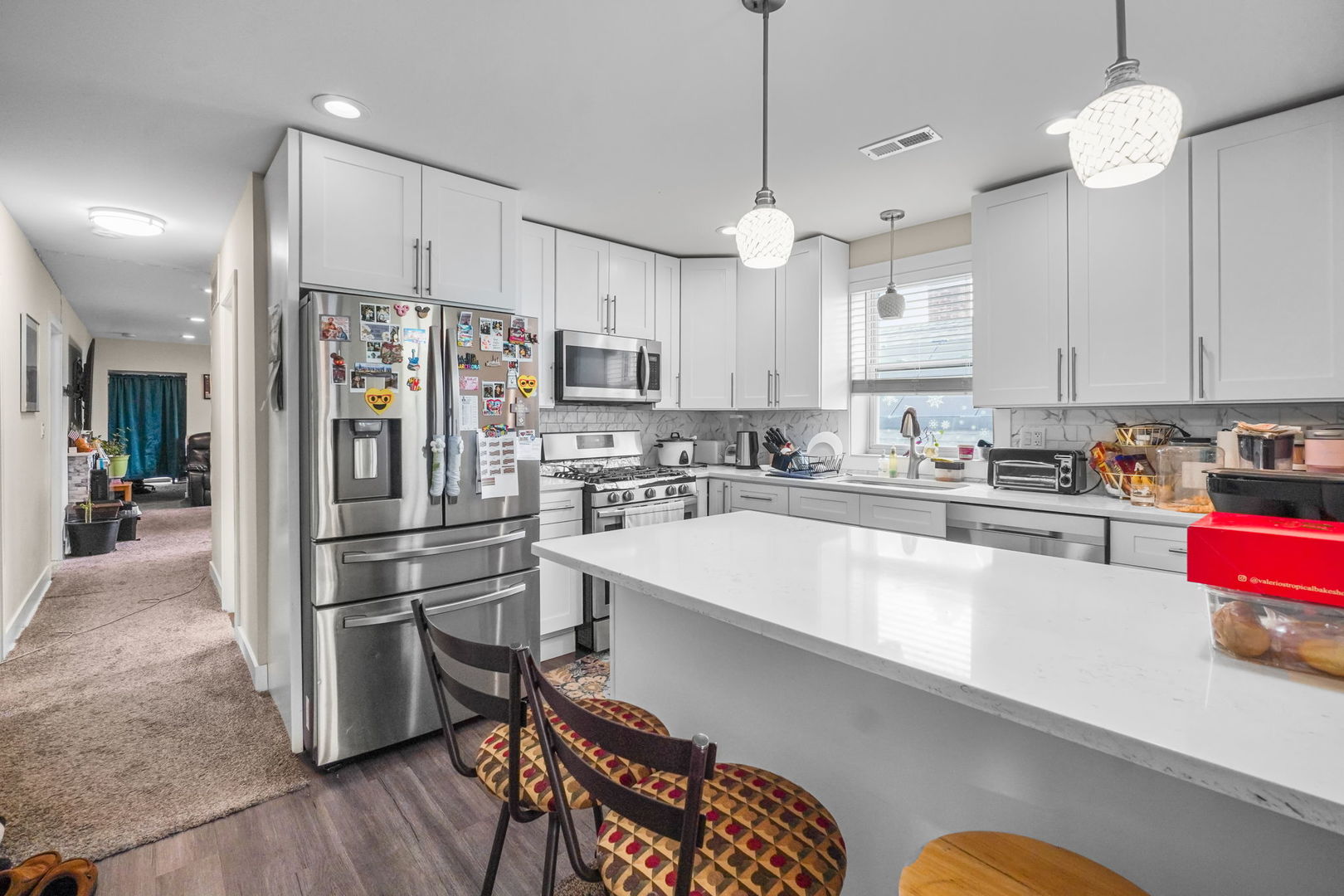 1906 South 60th Court Cicero, IL 60804 - Photo 27 of 40 a kitchen with stainless steel appliances a refrigerator a stove a sink dishwasher a dining table and chairs with wooden floor