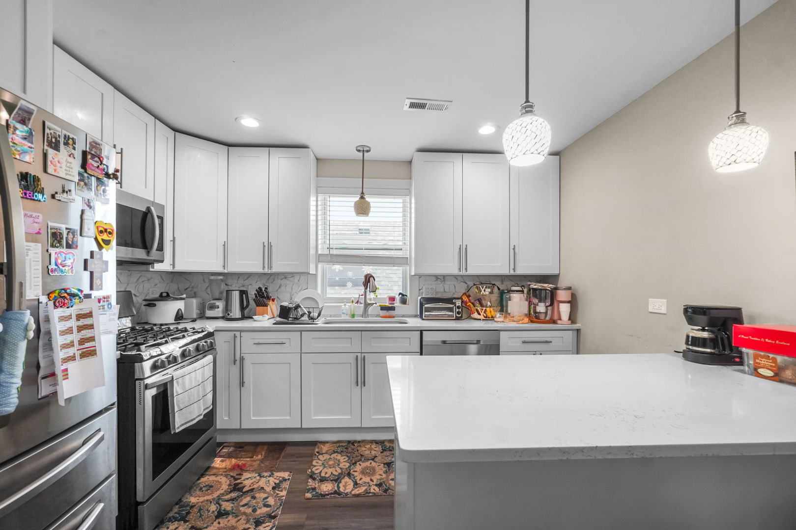1906 South 60th Court Cicero, IL 60804 - Photo 28 of 40 a kitchen with kitchen island granite countertop a sink a counter space stainless steel appliances and cabinets