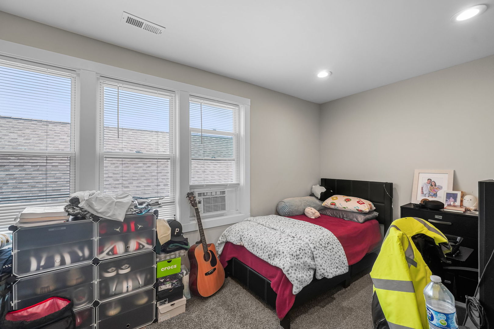1906 South 60th Court Cicero, IL 60804 - Photo 35 of 40 a bedroom with a bed a dresser and a large window
