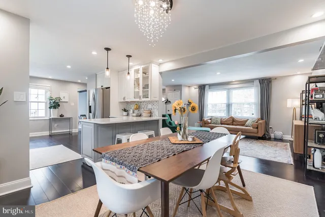 a dining room with kitchen island a table and chairs