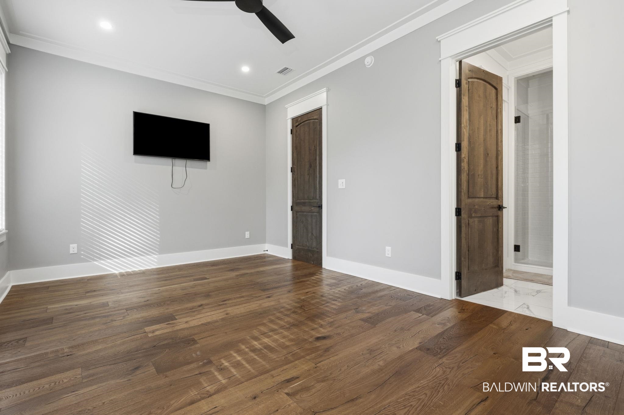 9501 Ben Hamilton Road Theodore, AL 36582 - Photo 39 of 69 Unfurnished bedroom with dark wood-style flooring, ornamental molding, a ceiling fan, recessed lighting, and ensuite bathroom