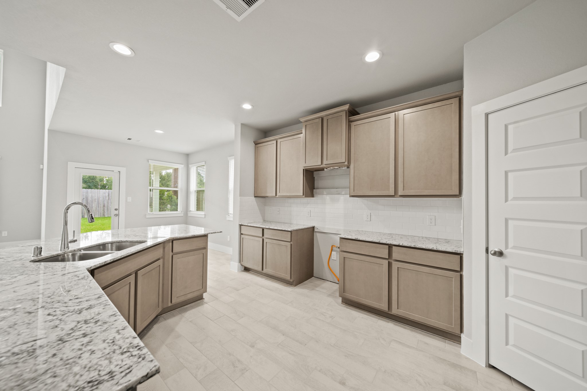 18227 Windy Knl Way Houston, TX 77084 - Photo 4 of 37 a large white kitchen with cabinets