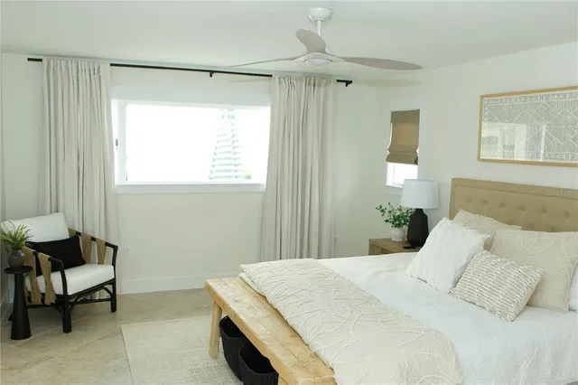 a bed room with a bed and a chair