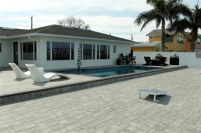 a view of a house with backyard and sitting area