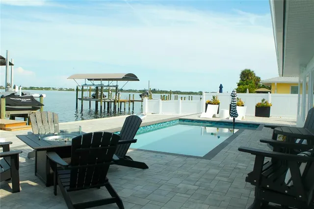a view of swimming pool with outdoor seating