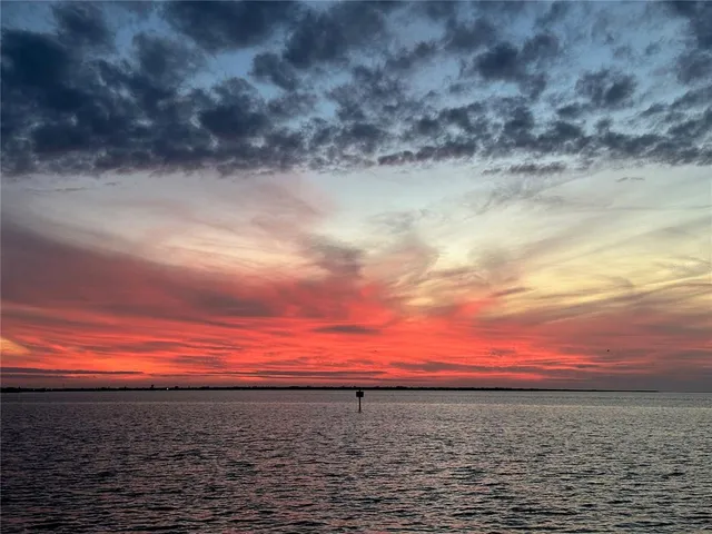 a view of a balcony with a floor to ceiling window next to a yard