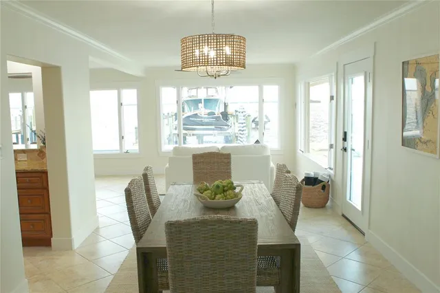 a dining room with furniture a chandelier and wooden floor