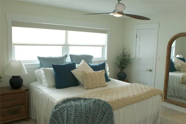 a bedroom with bed and window