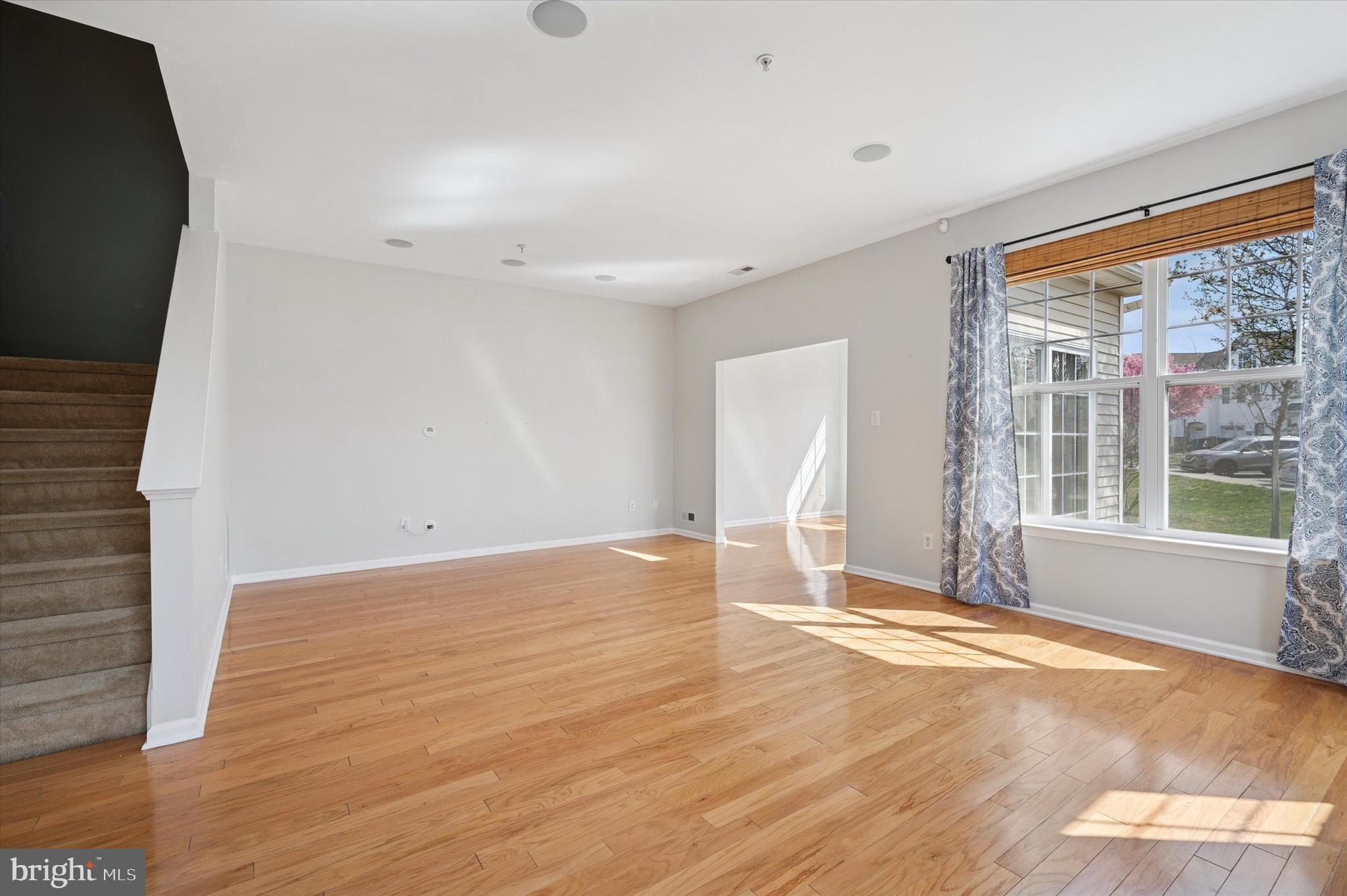 1 Old Cedarbrook Road Wyncote, PA 19095 - Photo 4 of 17 a view of an empty room with wooden floor and a window