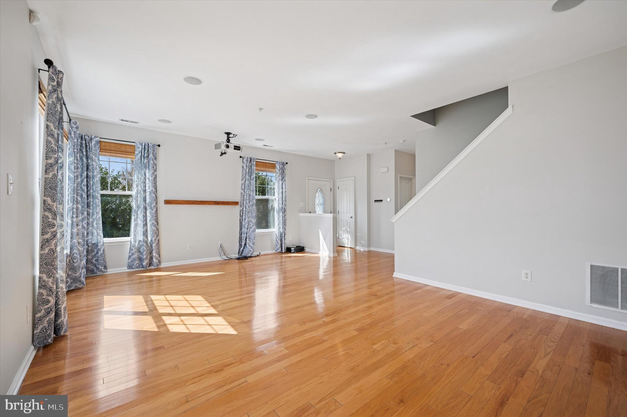 1 Old Cedarbrook Road Wyncote, PA 19095 - Photo 5 of 17 a view of an empty room with wooden floor and a window