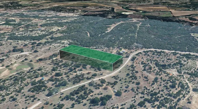 a street sign on a wall next to a road