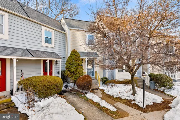 a view of a house with a yard and large tree