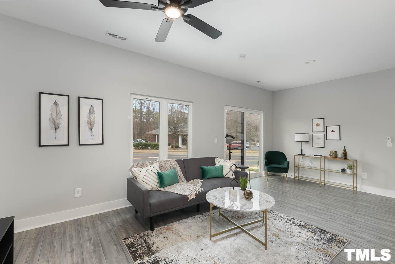 4 South Laird Drive, Unit 7 Clayton, NC 27520 - Photo 13 of 26 a living room with furniture and a wooden floor