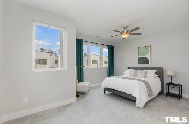 a spacious bedroom with a bed and a chandelier