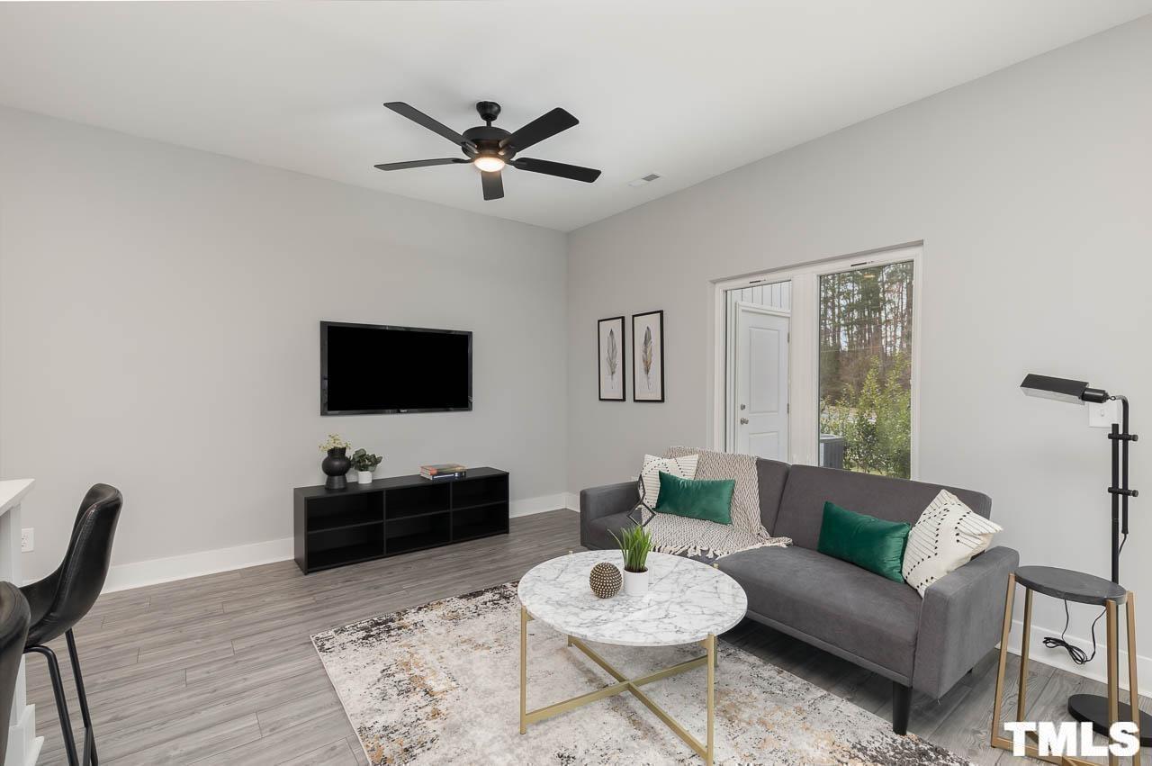 4 South Laird Drive, Unit 7 Clayton, NC 27520 - Photo 15 of 26 a living room with furniture a rug and a flat screen tv