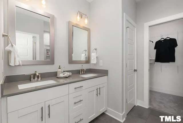 a bathroom with a double vanity sink and mirror