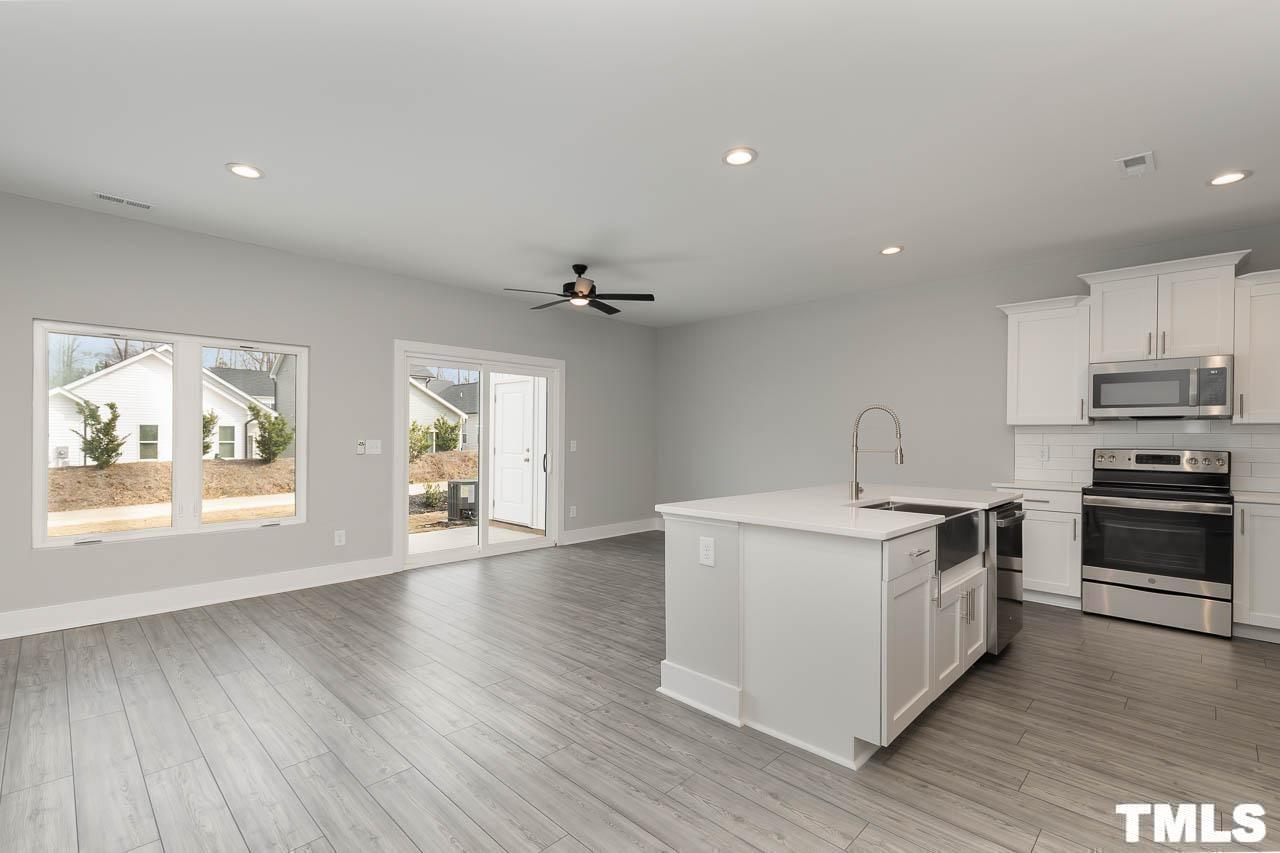 4 South Laird Drive, Unit 7 Clayton, NC 27520 - Photo 23 of 26 a kitchen with stainless steel appliances a white stove top oven and sink