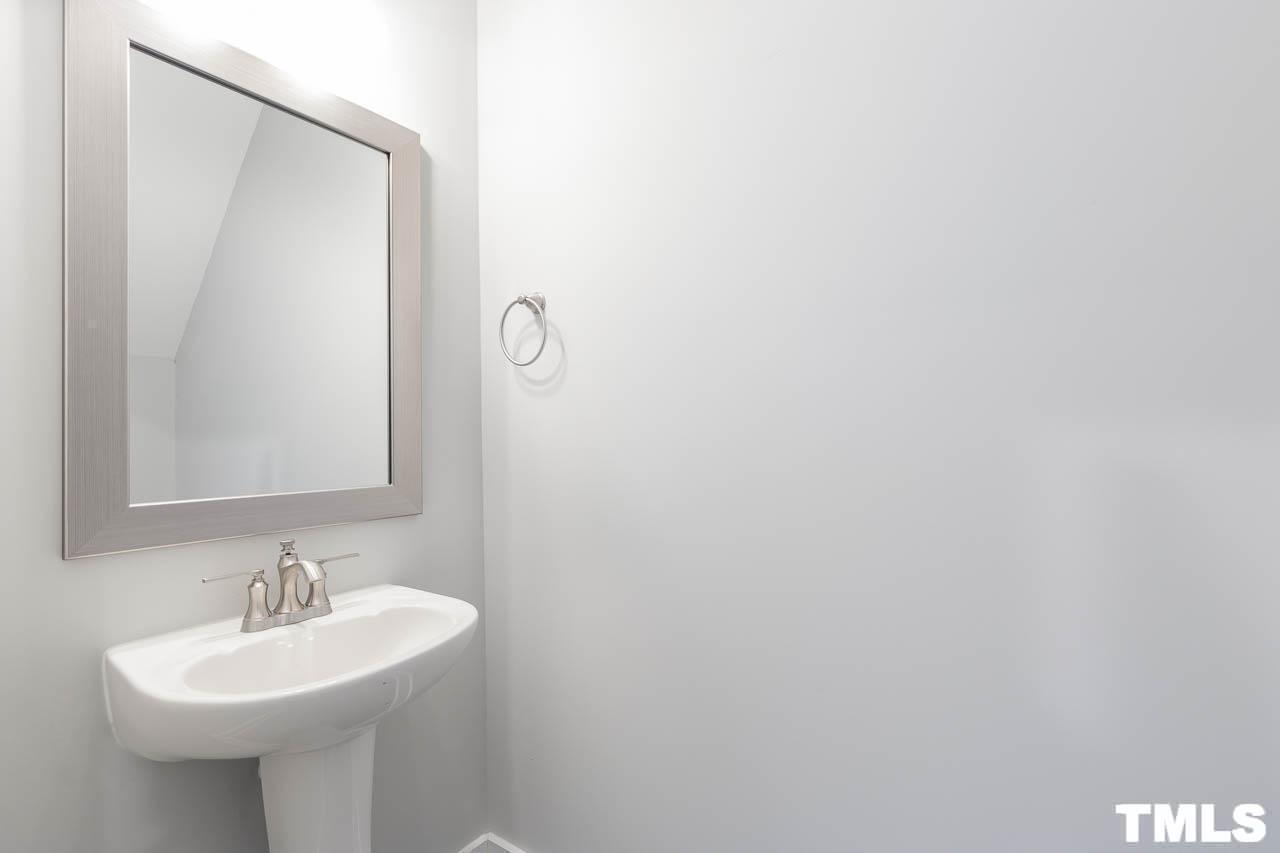 4 South Laird Drive, Unit 7 Clayton, NC 27520 - Photo 24 of 26 a bathroom with a sink and a mirror