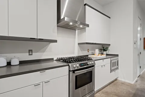 a stove top oven sitting inside of a kitchen