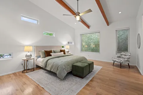 a bedroom with a bed and a couch