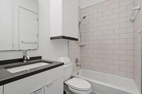 a bathroom with a sink a toilet and bathtub