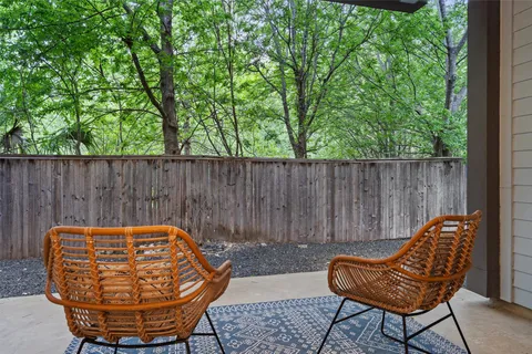 a backyard of a house with table and chairs