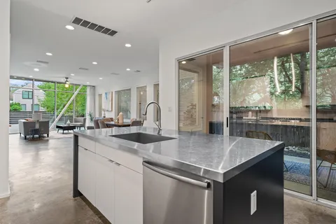 a view of kitchen island a sink and living room view