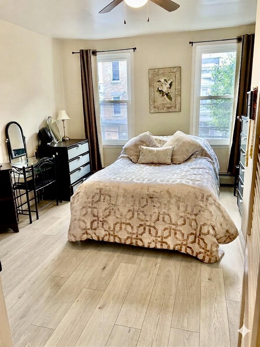 421 Adams Street, Unit 2L Hoboken, NJ 07030 - Photo 13 of 19 a bedroom with a bed and wooden floor