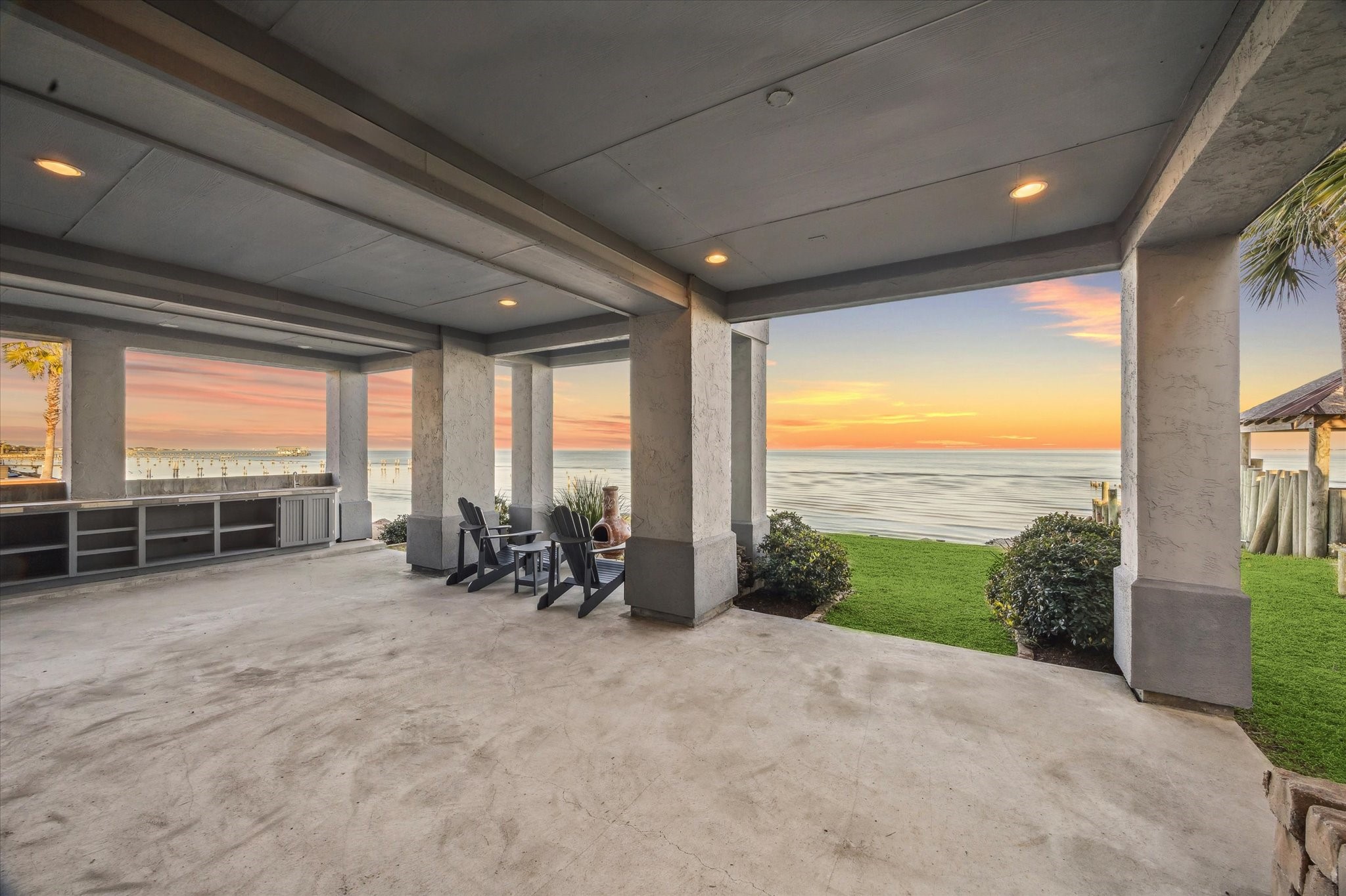 1406 Todville Road Seabrook, TX 77586 - Photo 46 of 49 GARAGE DOORS OPEN IN THE BACK CREATING ADDITIONAL OUTDOOR LIVING AREAS WITH BUILT-IN STORAGE AND A SINK.
