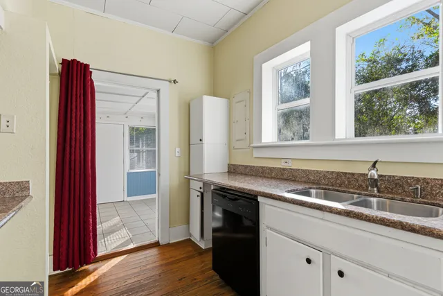 a kitchen with stainless steel appliances granite countertop a refrigerator and a stove