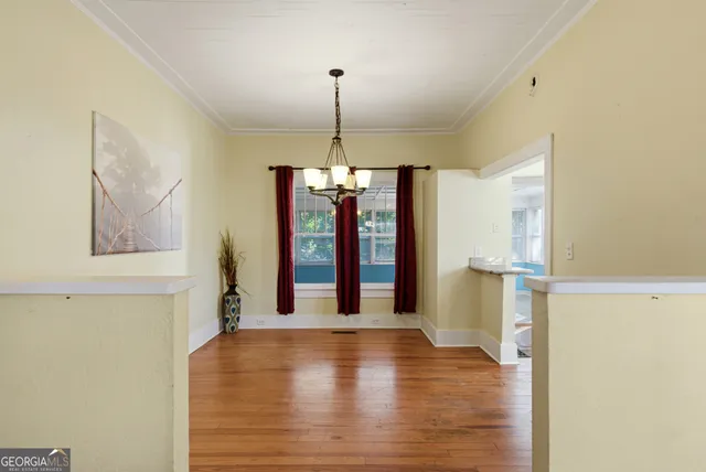 a view of a room with wooden floor and windows