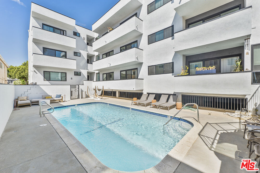821 3rd Street, Unit 305 Santa Monica, CA 90403 - Photo 2 of 13 a view of a patio with couches and a dining table under an umbrella