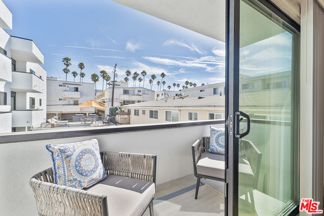 821 3rd Street, Unit 305 Santa Monica, CA 90403 - Photo 3 of 13 a view of a chairs and table in a balcony