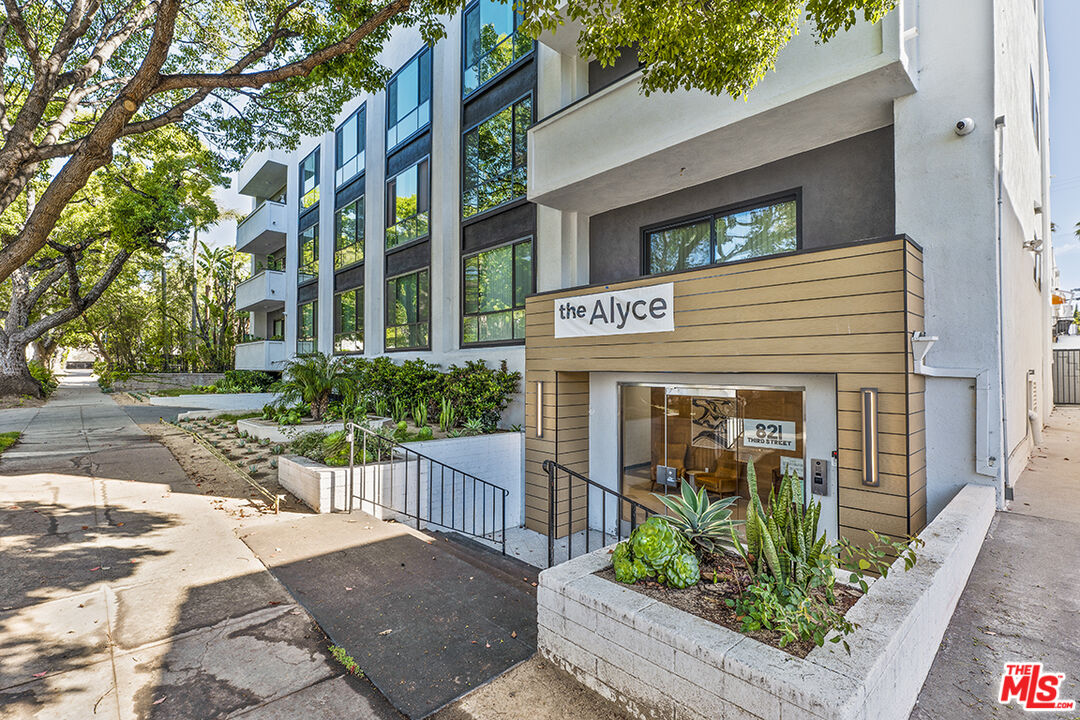 821 3rd Street, Unit 305 Santa Monica, CA 90403 - Photo 5 of 13 a view of a brick house with plants and large tree
