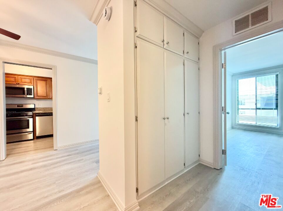 821 3rd Street, Unit 305 Santa Monica, CA 90403 - Photo 8 of 13 a view of a kitchen with wooden floor electronic appliances and windows