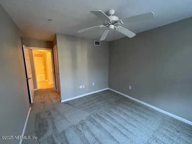 a view of a yard with wooden fence