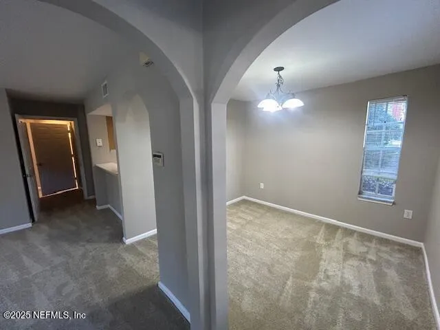 a view of a hallway with windows