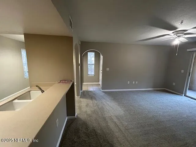 a view of a bathroom with a sink and chandelier