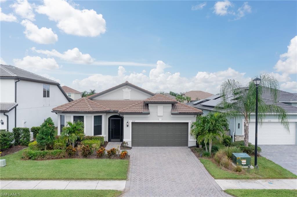 2137 Clementine Street Naples, FL 34120 - Photo 1 of 32 a front view of a house with garden