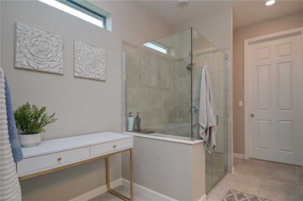 2137 Clementine Street Naples, FL 34120 - Photo 17 of 32 a bathroom with a shower and a sink